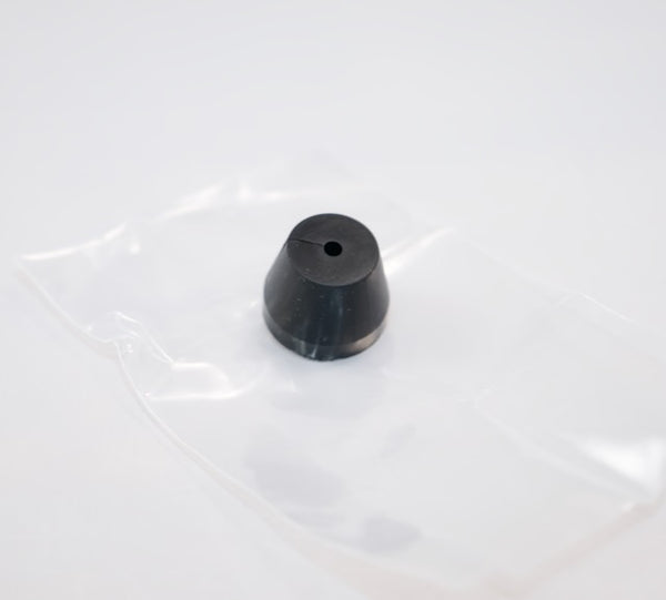 A small black rubber stopper by Outex, ideal for tripod adaptors, is shown on a clear plastic bag against a white background.