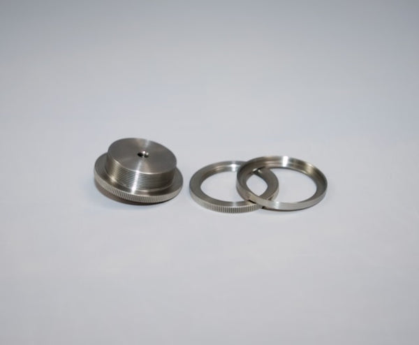 Three Outex metallic circular camera adaptors with ridged edges are displayed on a plain light gray background.