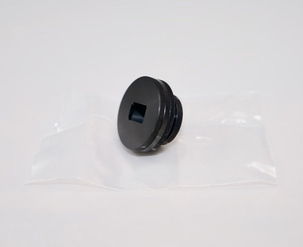 The Outex Accessories Miscellaneous Copy is a black metal plug with a square hole, ideal for tripod adaptors, shown on a clear plastic bag.