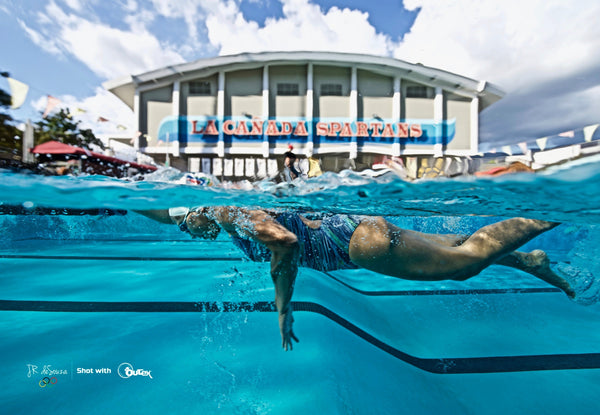 High school swimmer photographers half over half underwater