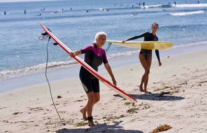 Two People Learning How To Surf