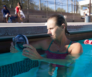 Outex waterproof phone case in use underwater showing side button access for camera control
