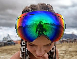 Photographer reflected in a Burning Man participant’s rainbow-mirrored goggles