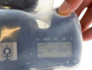 Photographer operating camera controls through Outex transparent waterproof housing cover underwater