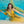 A woman with her arms spread in a yellow dress is inside a pool with blue water