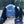 Hands with gloves holding a camera protected by an Outex case in the woods